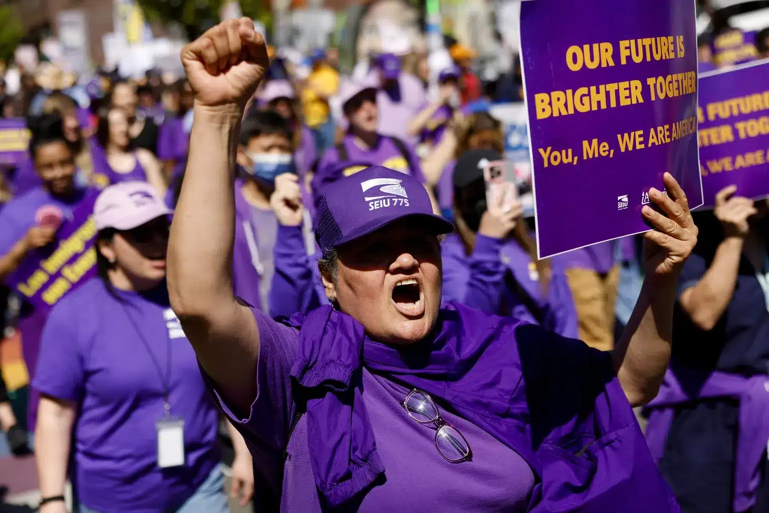 Woman cheering in a crowd of purple